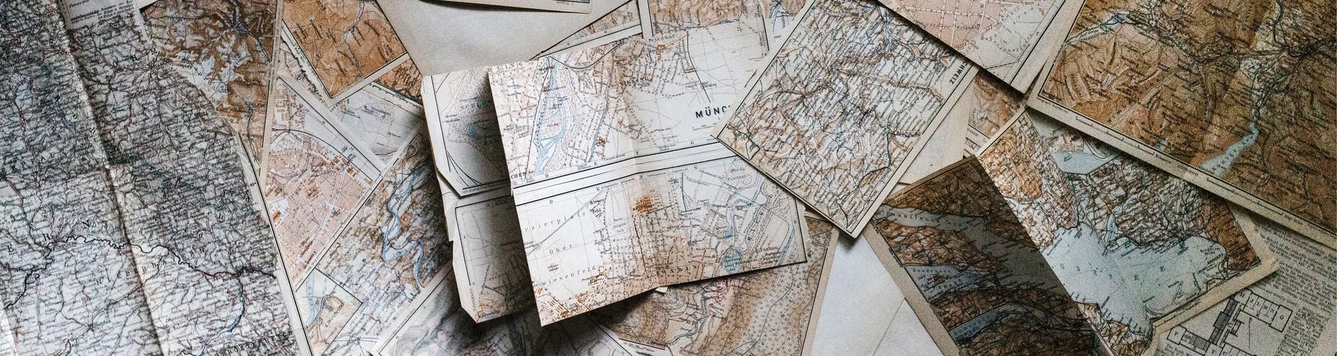 Scattered collection of old maps on a table